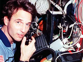 NASA/Mir-23 researcher Jerry Linenger with ham radio equipment in the Russian Mir Space Station Base Block module. 